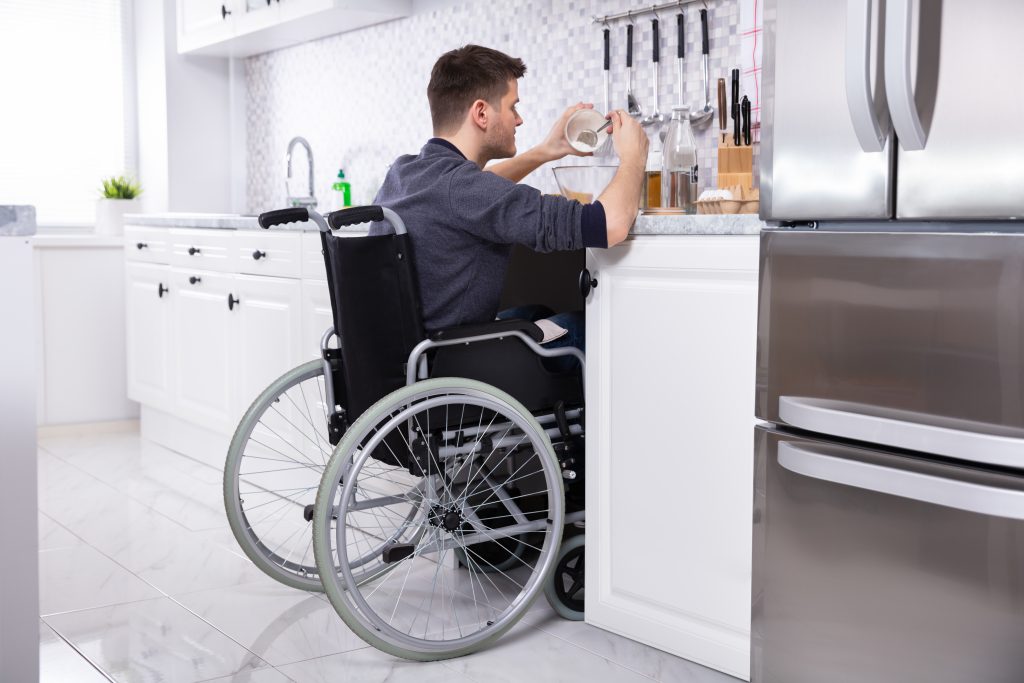 Image of man on a wheelchair in the kitchen