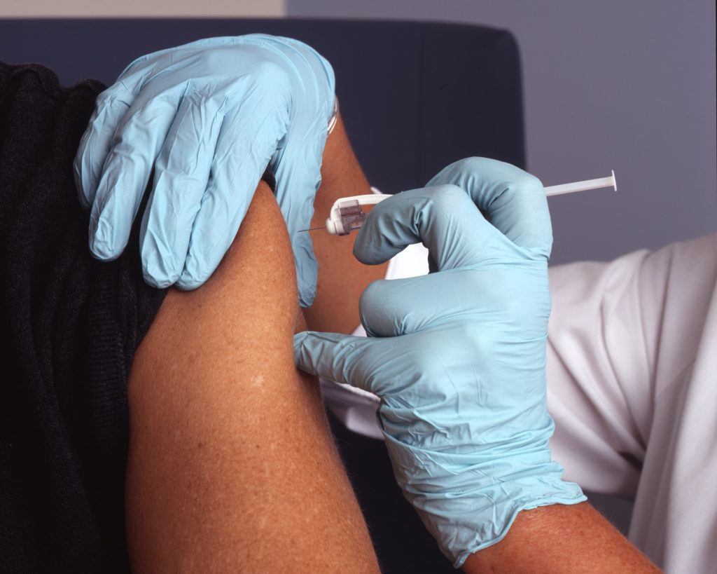 Image of a nurse vaccinating a patient