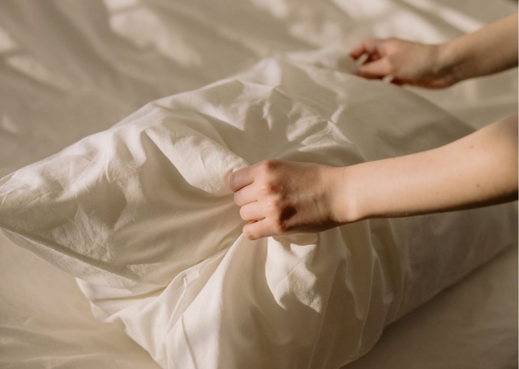 Image of woman hands holding a pillow