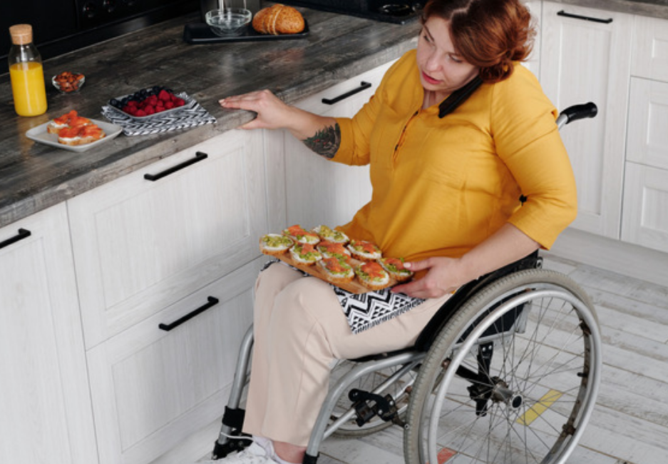 Image of woman on a wheelchair cooking