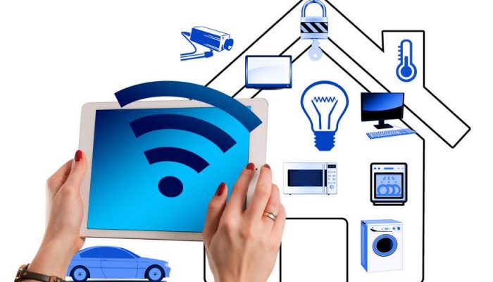 Image of two hands holding a remote control for home automation