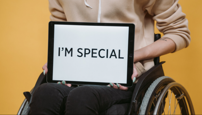 Image of woman on a wheelchair holding ipad